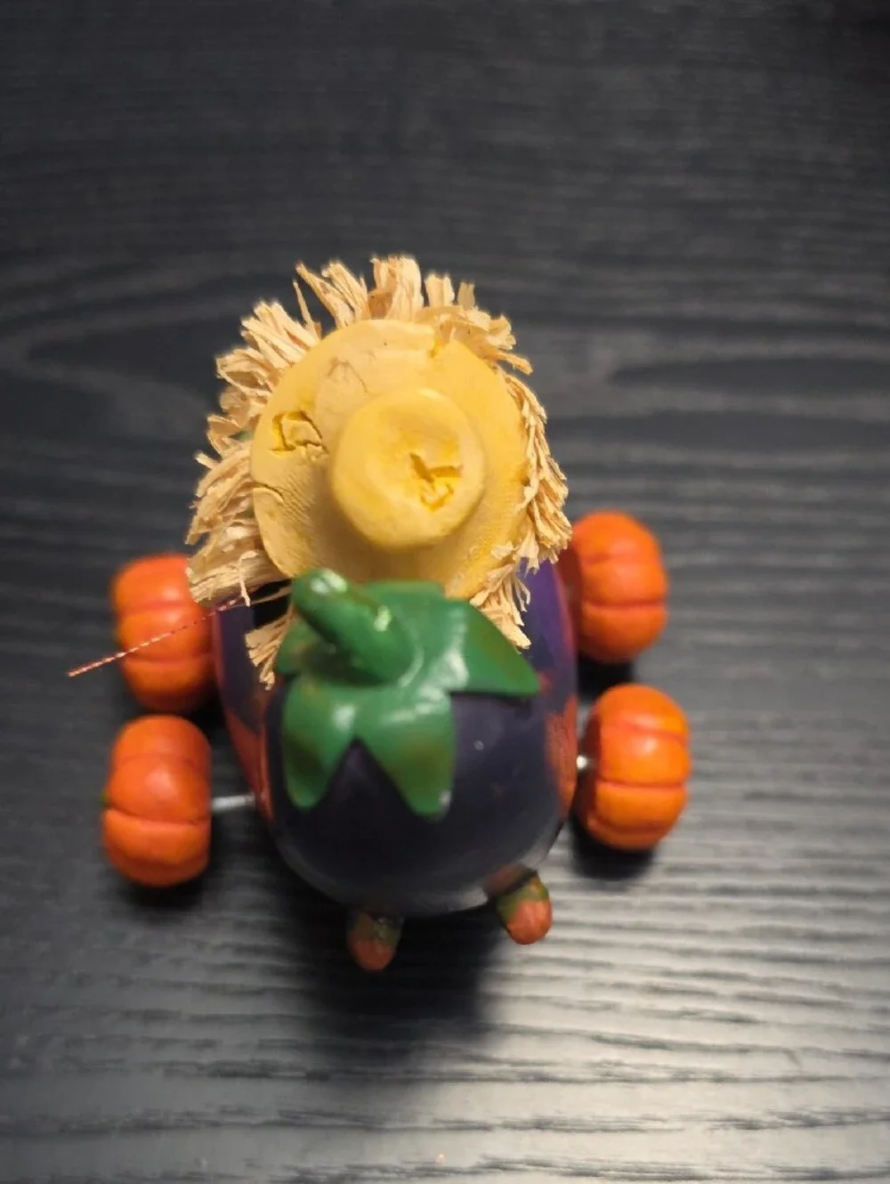 Autumn figurine of a scarecrow in a Eggplant cart
